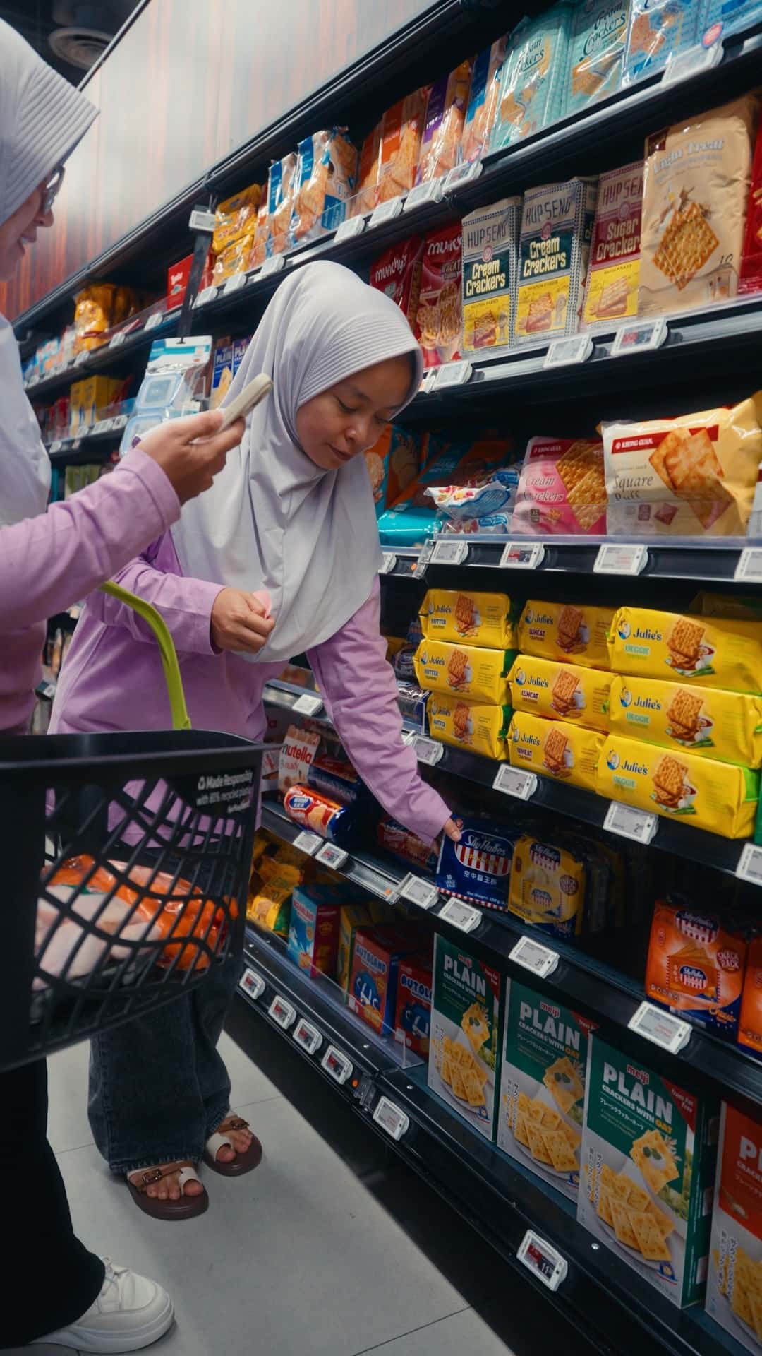 A domestic helper shopping for household groceries in a Singapore supermarket