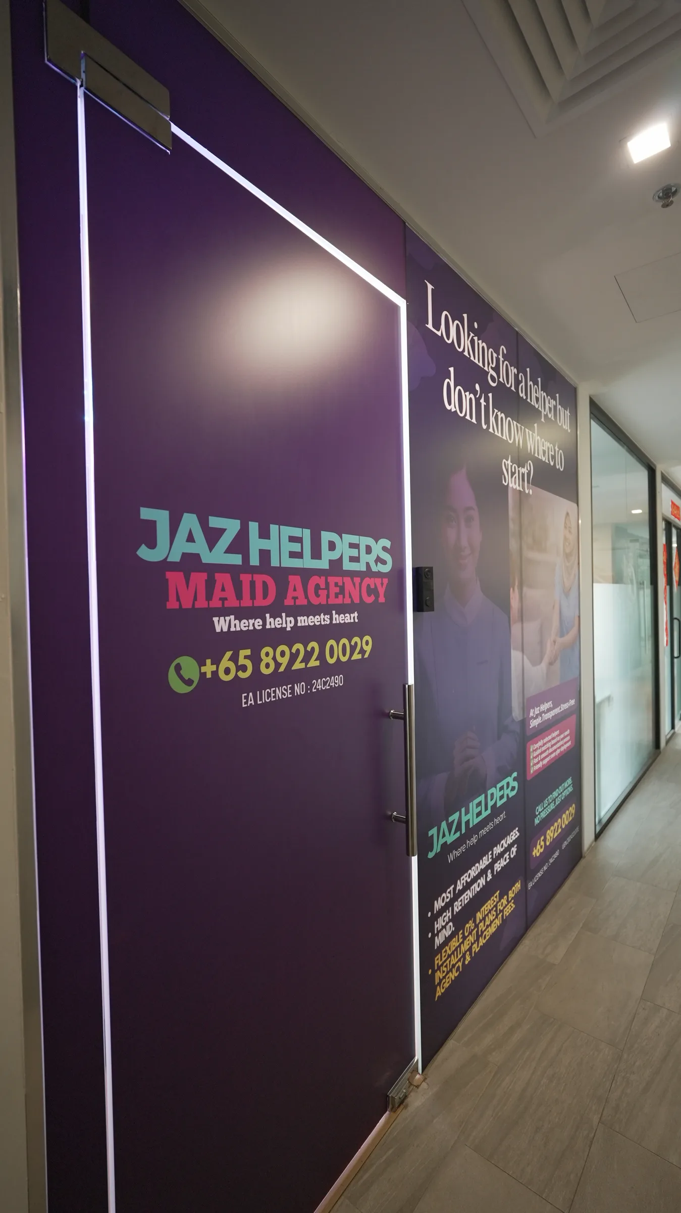 The purple Jaz Helpers Maid Agency door at unit 02-13